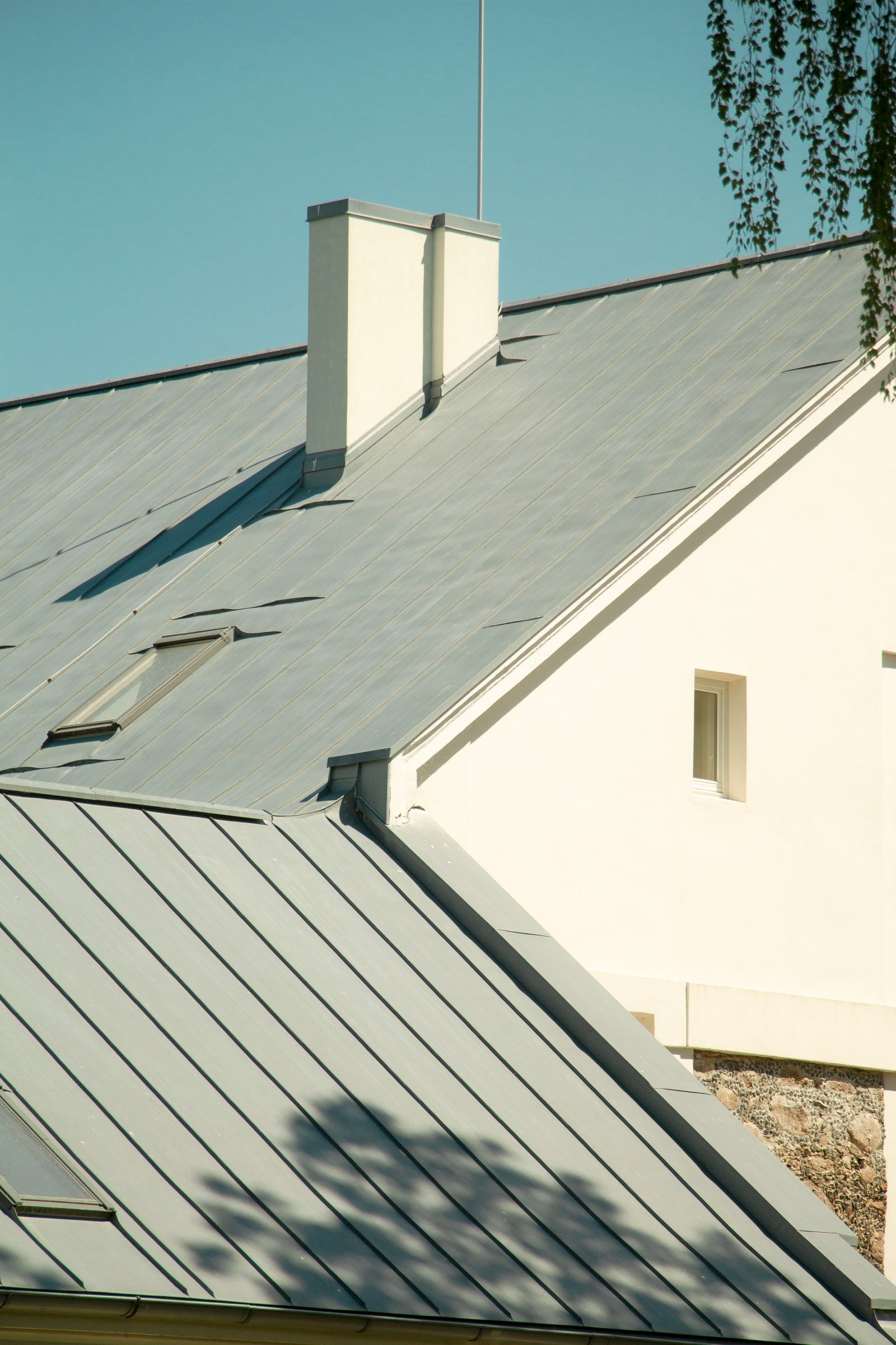Standing-seam metal roofing installation on a modern home in Dripping Springs, Texas